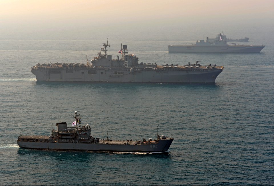 The amphibious assault ship USS Bonhomme Richard (LHD 6), center, transits the East China Sea with the South Korean amphibious assault ship ROKS Dokdo (LPH 6111), right, and the South Korean amphibious dock 140327-N-BJ178-218