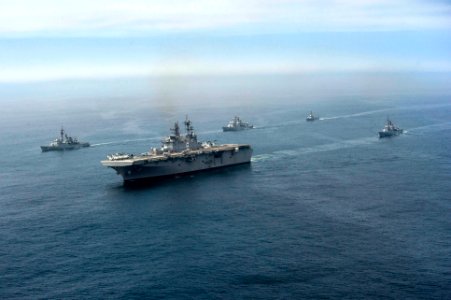 The amphibious assault ship USS America (LHA 6), center, and Peruvian Navy ships sail in formation during a passing exercise in the Pacific Ocean Sept 140903-N-MZ309-847