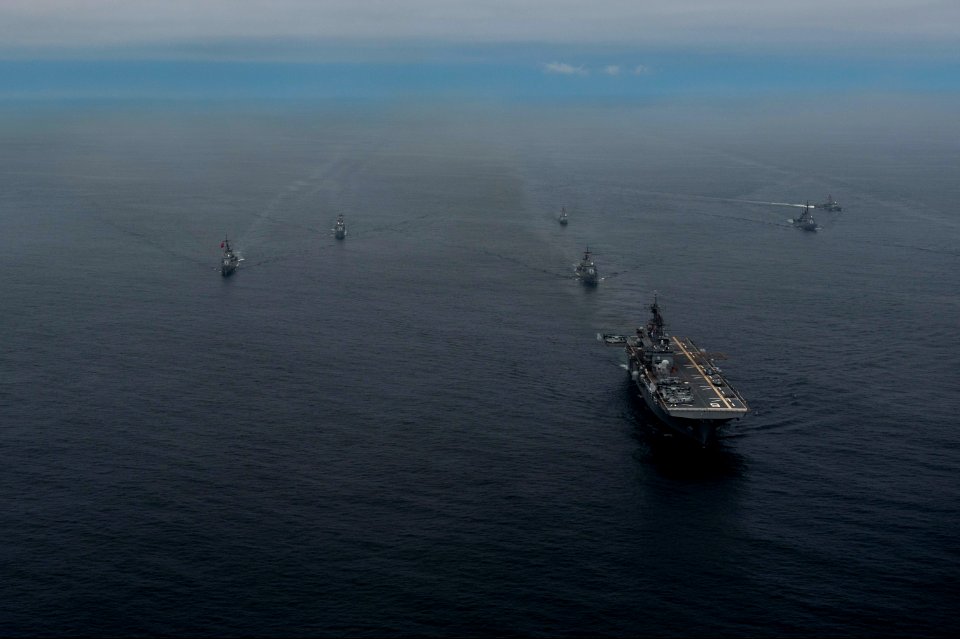 The amphibious assault ship USS America (LHA 6), right front, and Peruvian Navy ships sail in formation during a passing exercise in the Pacific Ocean Sept 140903-N-MZ309-1244