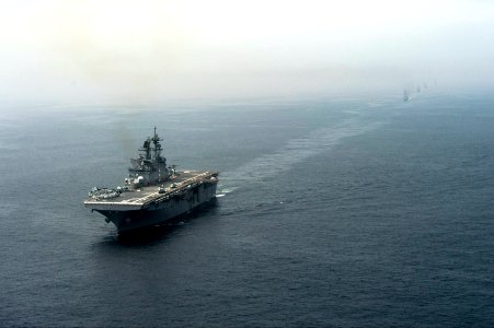 The amphibious assault ship USS America (LHA 6), left, and Peruvian Navy ships sail in formation during a passing exercise in the Pacific Ocean Sept 140903-N-MZ309-065