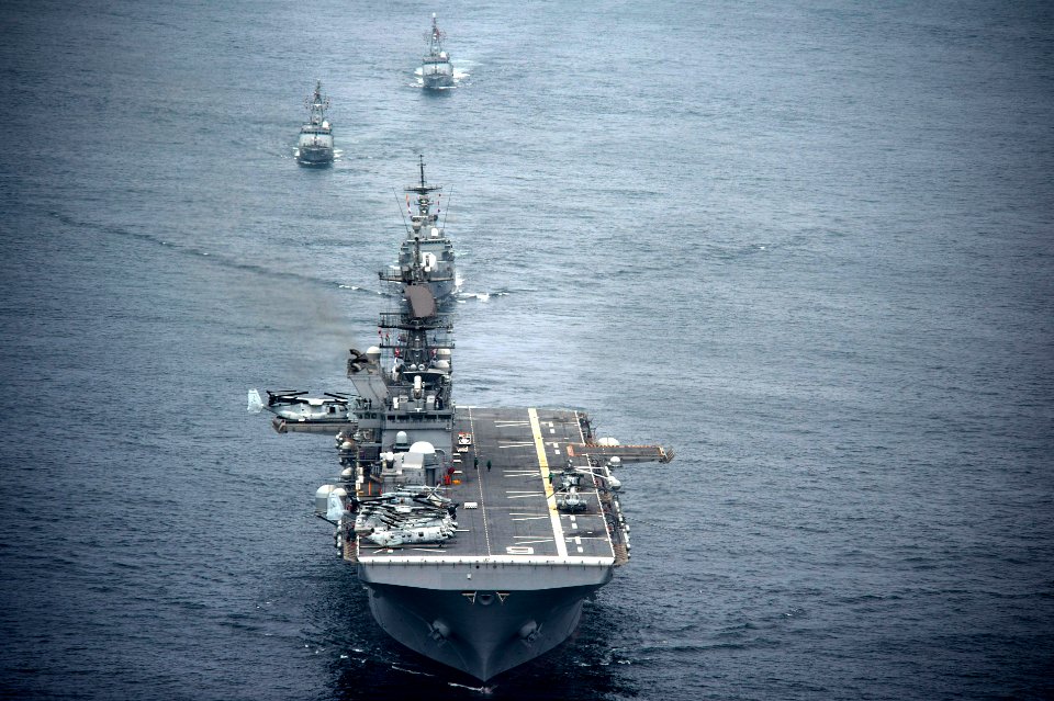 The amphibious assault ship USS America (LHA 6), front, and Peruvian Navy ships sail in formation during a passing exercise in the Pacific Ocean Sept 140903-N-MZ309-1097
