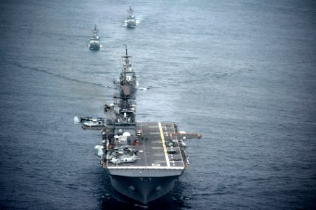 The amphibious assault ship USS America (LHA 6), front, and Peruvian Navy ships sail in formation during a passing exercise in the Pacific Ocean Sept 140903-N-MZ309-1097