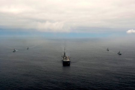 The amphibious assault ship USS America (LHA 6), center, and Peruvian Navy ships sail in formation during a passing exercise in the Pacific Ocean Sept 140903-N-MZ309-1131