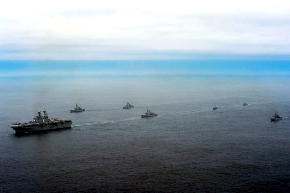 The amphibious assault ship USS America (LHA 6), left, and Peruvian Navy ships sail in formation during a passing exercise in the Pacific Ocean Sept 140903-N-MZ309-1183