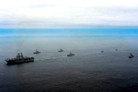 The amphibious assault ship USS America (LHA 6), left, and Peruvian Navy ships sail in formation during a passing exercise in the Pacific Ocean Sept 140903-N-MZ309-1183