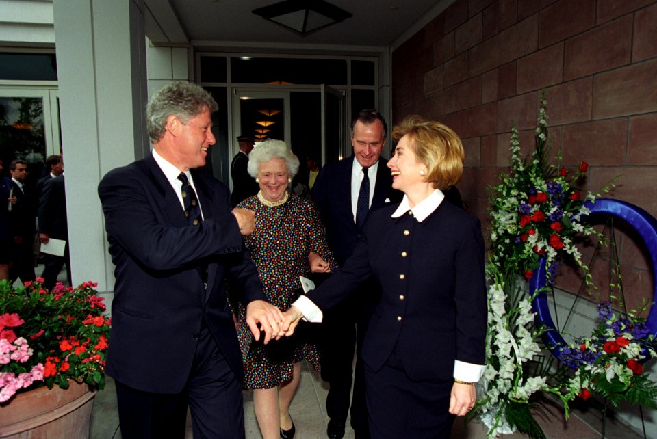 The Clintons walking with President George H. W. Bush and Barbara Bush following President Nixon's funeral