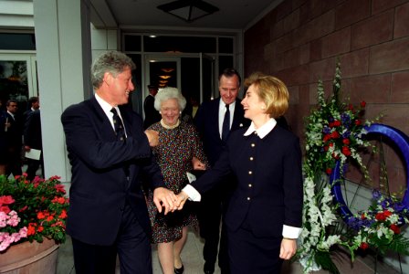 The Clintons walking with President George H. W. Bush and Barbara Bush following President Nixon's funeral photo