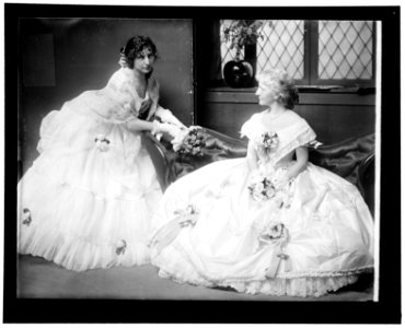 The Gerson sisters posed on a sofa in their Crinoline Ball costumes. New York City LCCN2006684249