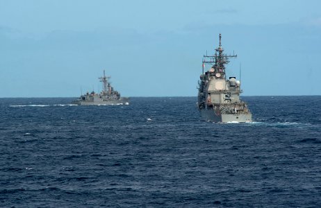 The guided missile frigate USS Samuel B. Roberts (FFG 58) and the guided missile cruiser USS Vella Gulf (CG 72) maneuver into formation in the Atlantic Ocean March 17, 2014, while traveling to Scotland to 140317-N-WX580-151