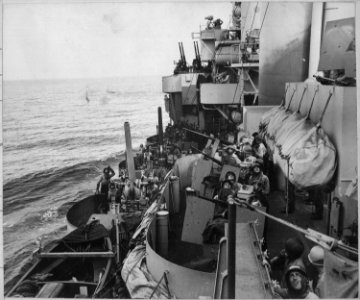 The gun crews of a Navy cruiser covering American landing on the island of Mindoro, December 15, 1944, scan the skies... - NARA - 520615