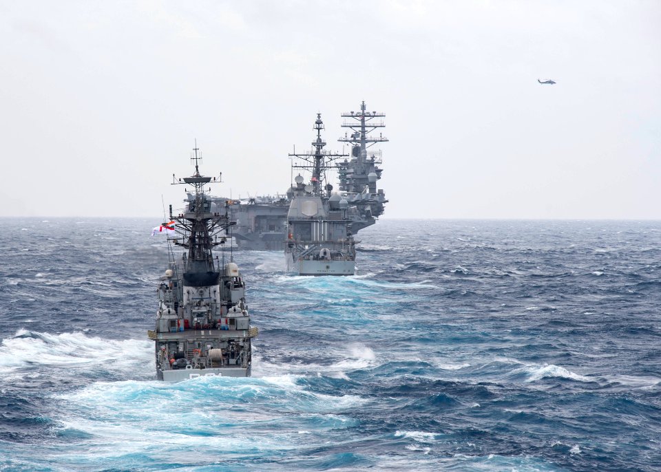 The Kora-class corvette INS Kora (P 61) steams behind the guided-missile cruiser USS Princeton (CG 59) and the aircraft carrier USS Nimitz (CVN 68) during Malabar 2017