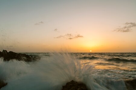 Waves splash sunset