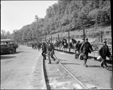 The man trip pulls in and the miners rush to check in their safety lamps and identification tags. The Pocahontas... - NARA - 541083