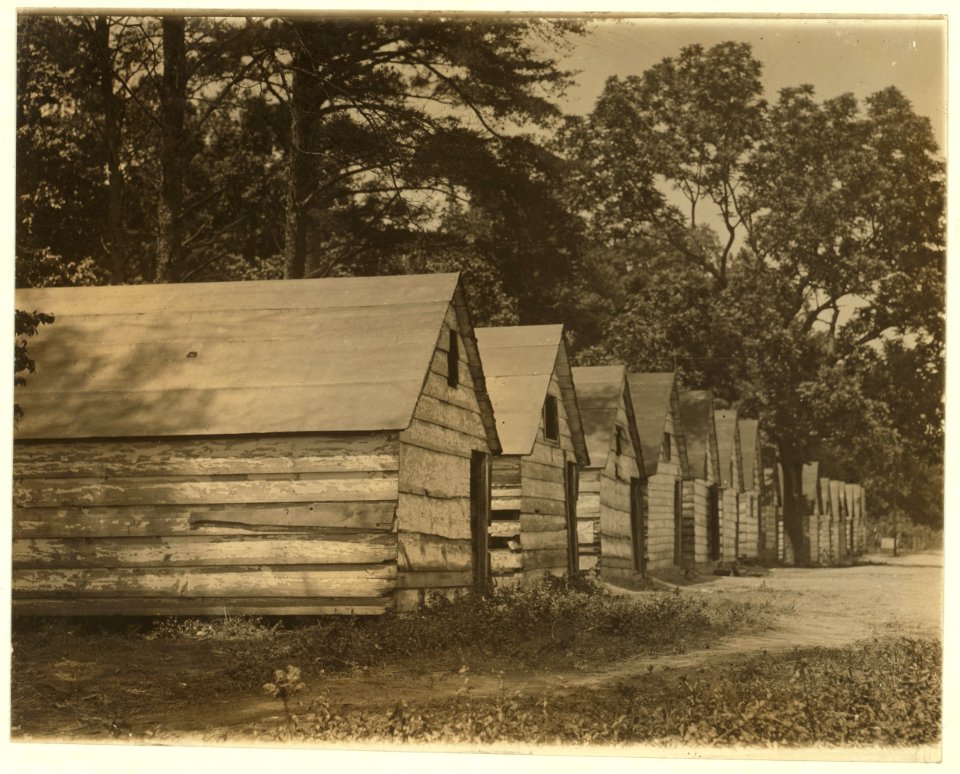 The negro berry pickers shacks on the farm of Col. J. J. Ross, Del. The interior of these shacks consists of a flooring of straw, a few bags, and absence of light and air. LOC nclc.00092