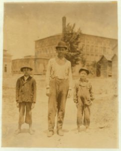 The Norton boys and father on the way home to dinner. Smallest boy Edgar been sweeping 3 months in Saxon Mill, Spartanberg. Makes about 40 cents a day. His brother makes 60 cents. Father LOC nclc.02563