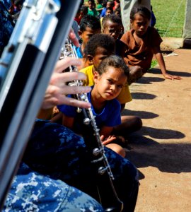 The Pacific Fleet Band entertains children in Savusavu, Fiji, during Pacific Partnership 2015 150612-N-HE318-037