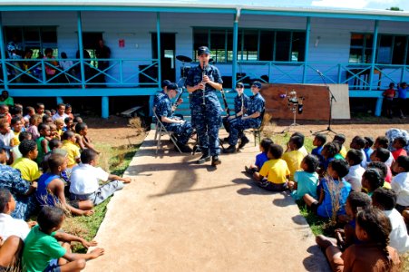 The Pacific Fleet Band entertains children in Savusavu, Fiji, during Pacific Partnership 2015 150612-N-HE318-053