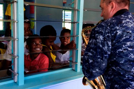 The Pacific Fleet Band entertains children in Savusavu, Fiji, during Pacific Partnership 2015 150612-N-HE318-085