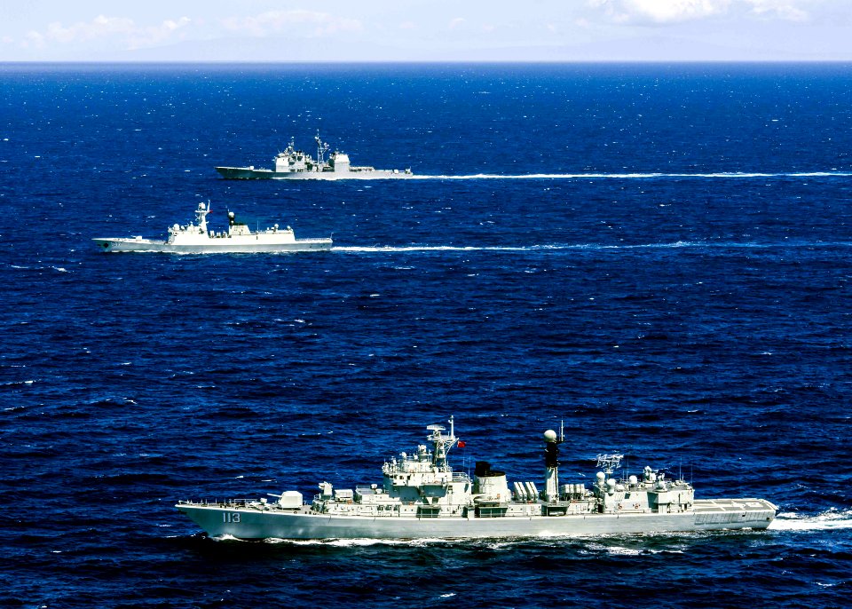 The People's Liberation Army-Navy destroyer Qingdao (DDG 113), foreground, frigate Linyi (FFG 547), and the U.S. Navy guided-missile cruiser USS Lake Erie (CG 70) operate together off Oahu, Hawaii, during a search and rescue exercise