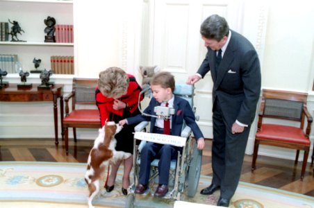 The Reagans with dog Rex and Photo Op. with the 1986 National Easter Seal Child in oval office