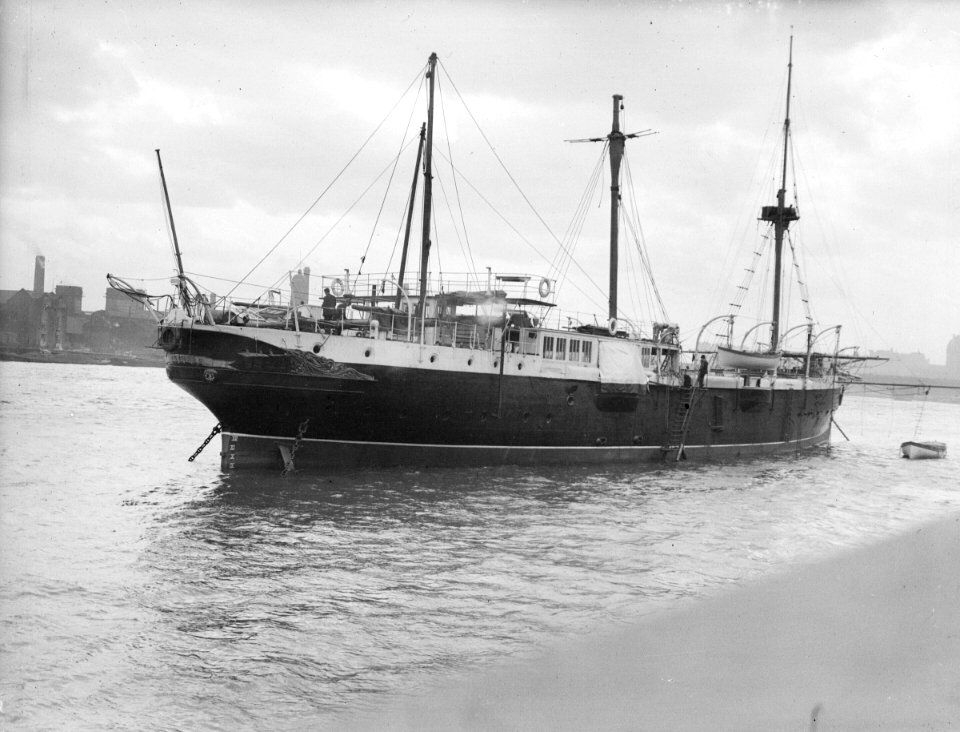 The RNVR Training Ship 'Buzzard' (1887) moored in the River Thames at the Embankment. RMG P00042