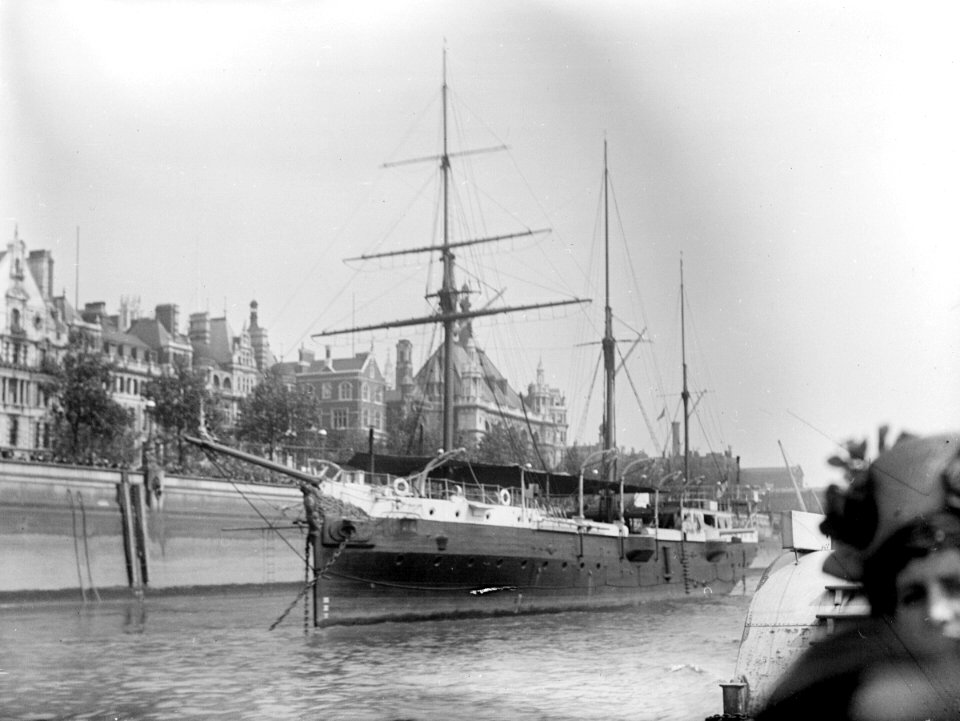 The RNVR Training Ship Buzzard (1887) moored in the River Thames at the Embankment. RMG P00043