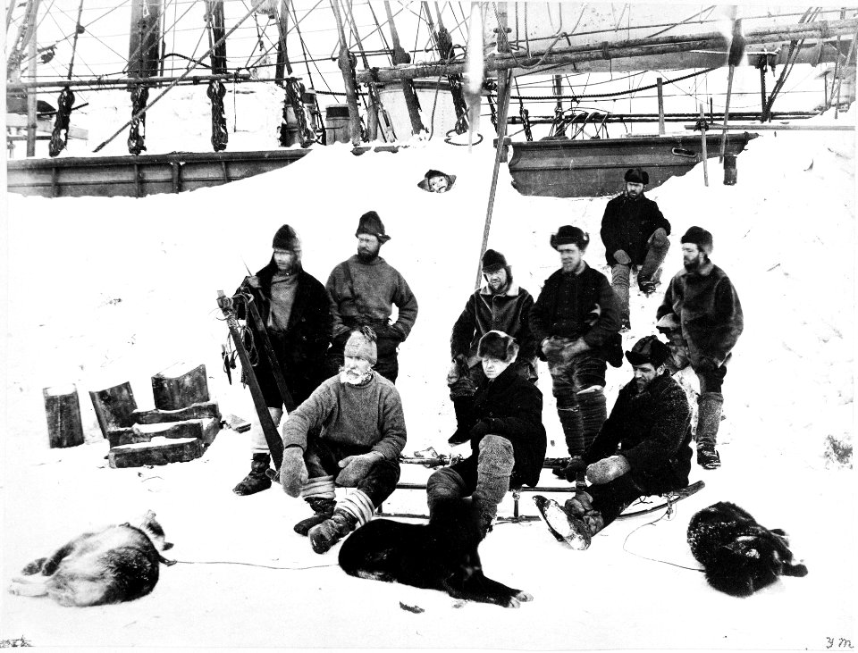 The shipkeepers of 'Discovery' (1873) sitting on a dog sledge with the remaining dogs. RMG P39588