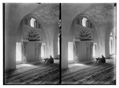 The Temple area. Mosque el Aksa (i.e., al-Aqsa), int(erior). Chapel of Omar. Reader before Omar's mihrab made of Byzantine entwined columns. LOC matpc.02513