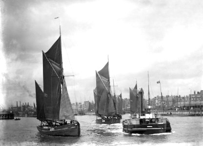 The trawler LT372 under sail with LT205 in tow of the paddle tug 'Imperial' (1879) leaving the harbour. RMG P27506