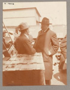Theodore Roosevelt conversing with a man on deck of ship. Passengers in background LCCN2013650590