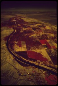 The-colorado-river-feeds-crops-and-vegetation-dark-areas--town-of-needles-in-foreground-may-1972 6990318628 o