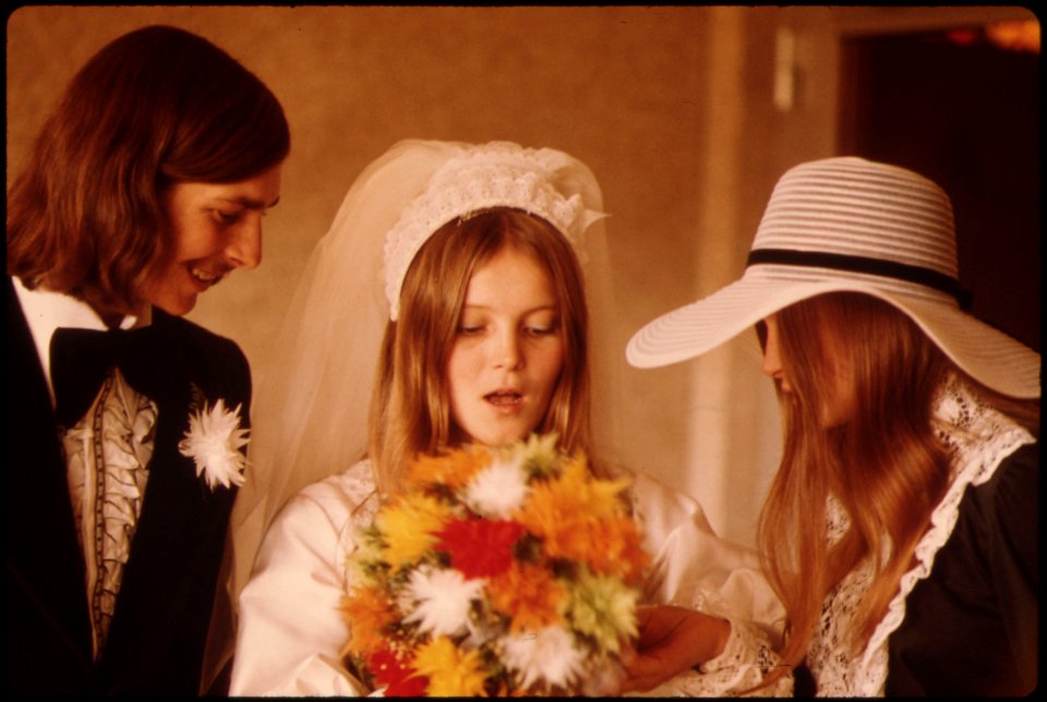 The-bride-and-groom-and-a-member-of-the-wedding-party-with-a-bouquet-at-new-ulm-minnesota 4727529366 o