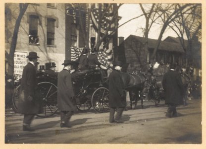 Theodore Roosevelt and 2 other men in horse-drawn carriage, men walking along side, during inauguration day LCCN92500044