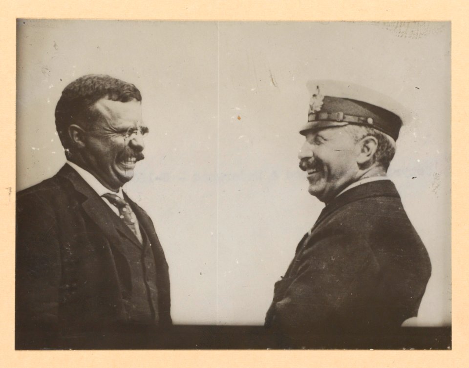 Theodore Roosevelt and a man in uniform laughing LCCN2013650571
