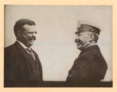 Theodore Roosevelt and a man in uniform laughing LCCN2013650571