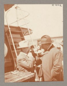 Theodore Roosevelt conversing with a man on deck of ship LCCN2013650588