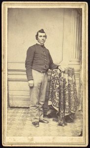 Theodore H. Marsh, Co. L 27 New Jersey, full-length studio portrait, standing with left arm resting on studio prop, facing slightly right, wearing military uniform LCCN2005677264