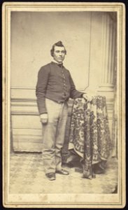 Theodore H. Marsh, Co. L 27 New Jersey, full-length studio portrait, standing with left arm resting on studio prop, facing slightly right, wearing military uniform LCCN2005677264