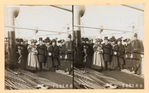 Theodore Roosevelt in group portrait surrounded by women and naval officers on deck of ship LCCN2013650581