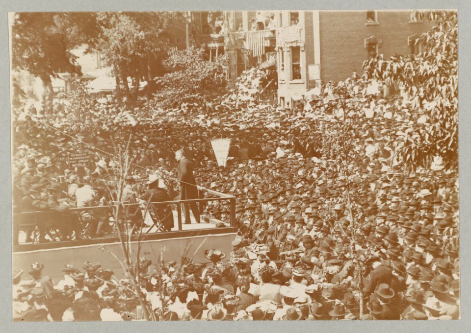 Theodore Roosevelt on a platform speaking to a large group, possibly veterans LCCN2009633780