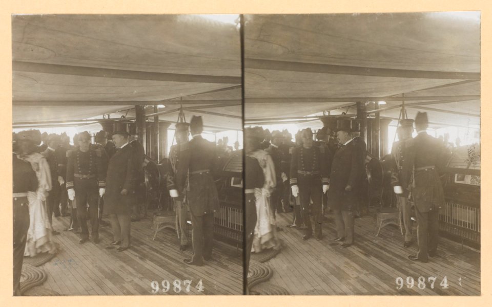 Theodore Roosevelt on deck of ship surrounded by naval officers and a woman passing by LCCN2013650578