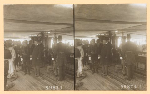 Theodore Roosevelt on deck of ship surrounded by naval officers and a woman passing by LCCN2013650578 photo