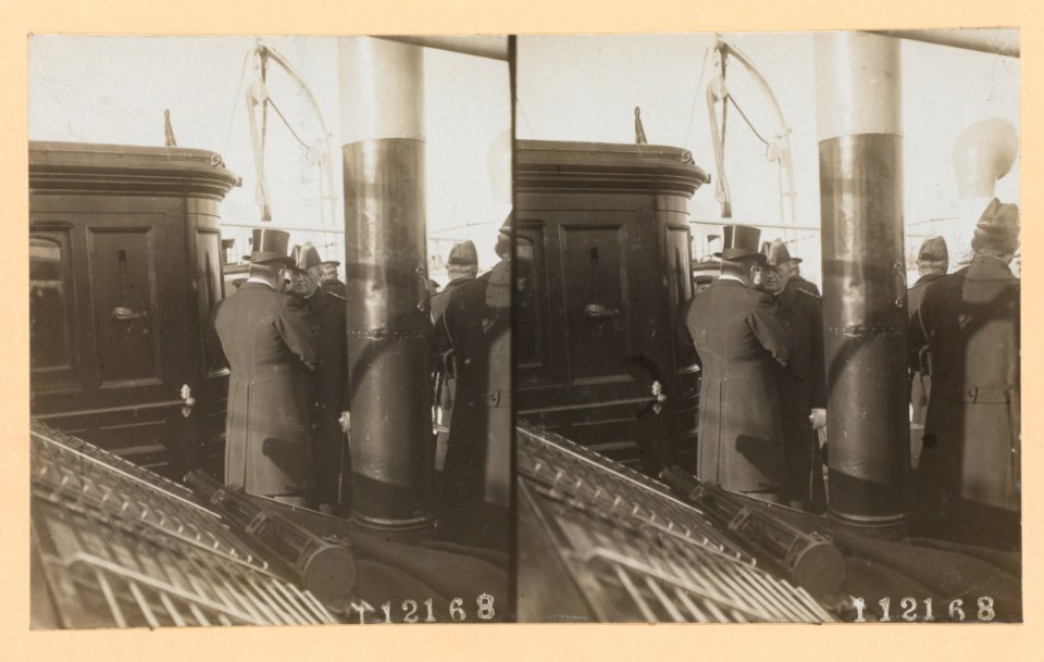 Theodore Roosevelt on deck of ship, back to camera, conversing with a naval officer LCCN2013650591