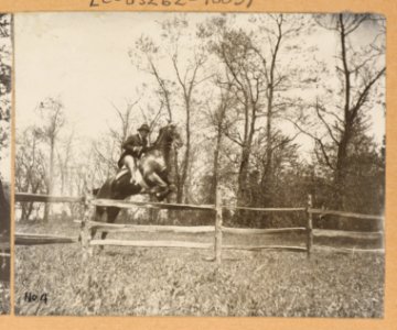 Theodore Roosevelt on horseback jumping over a split rail fence LCCN2011645287
