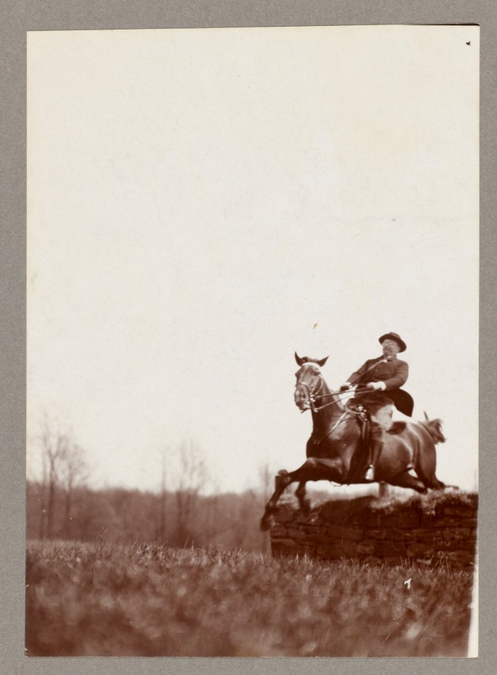 Theodore Roosevelt on horseback jumping over stone wall LCCN2013649643