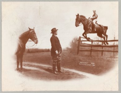 Theodore Roosevelt watching his son Theodore Jr., who is riding on horse jumping over fence LCCN92520947