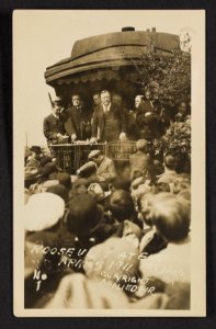 Theodore Roosevelt with others standing on back of train, facing crowd. Eugene, Ore. April 5, 1911 LCCN2003675034