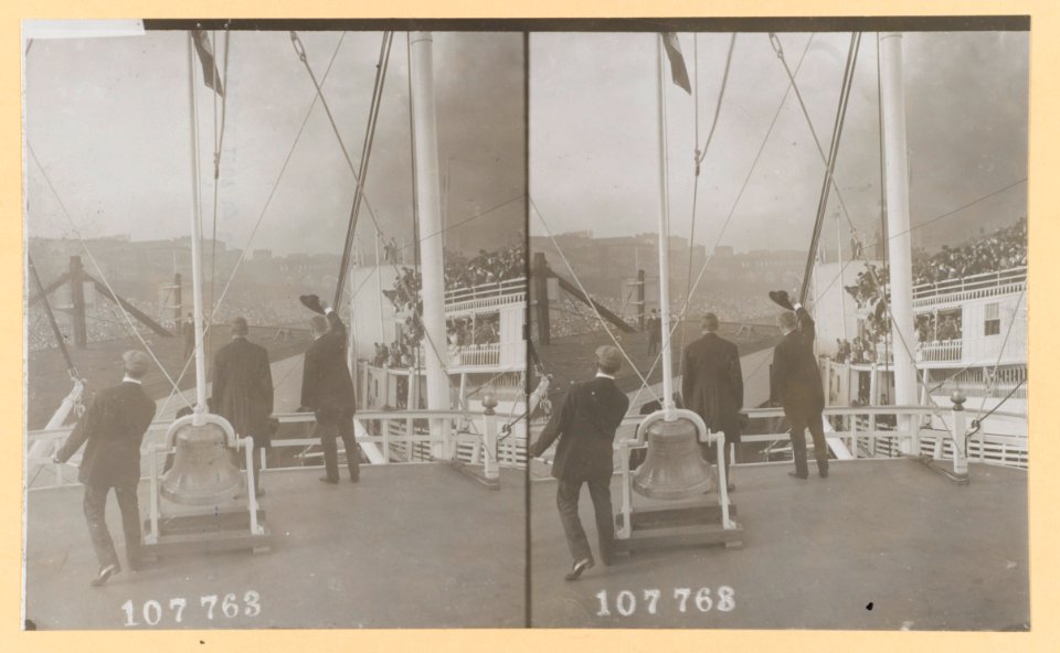 Theodore Roosevelt, and two other men, standing on deck of a ship, with their backs to camera, Roosevelt waving his hat to the crowd on another ship LCCN2013650575