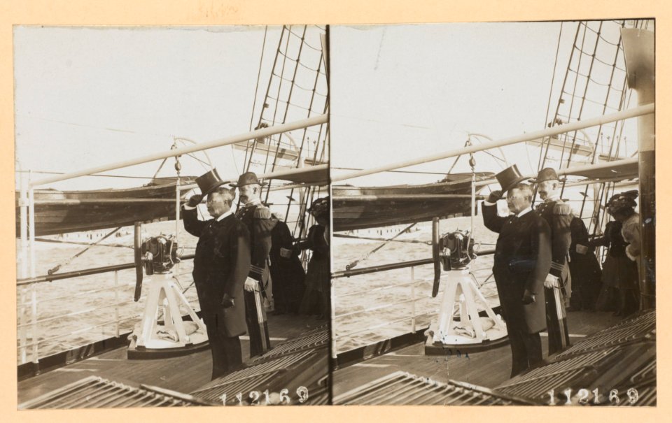 Theodore Roosevelt, full-length portrait, facing left, standing on deck of ship, with a naval officer LCCN97520210