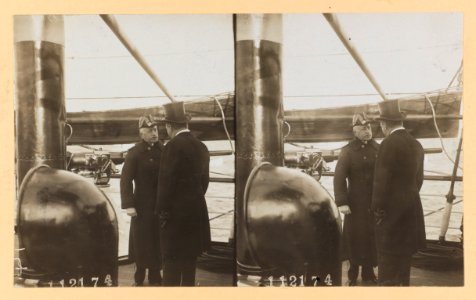 Theodore Roosevelt, back to camera, conversing with a naval officer on deck of ship LCCN2013650583 photo